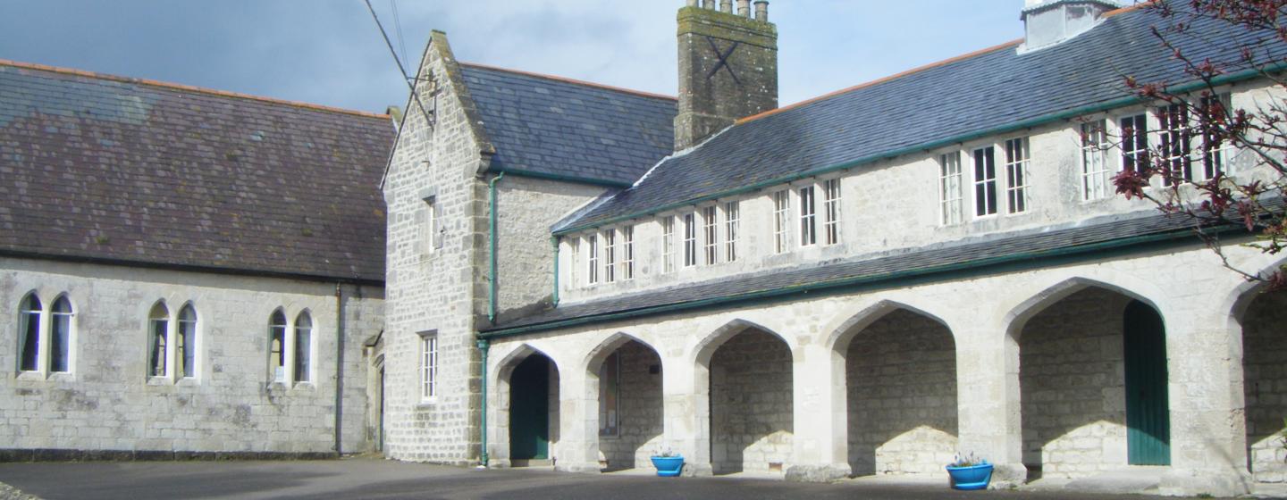 A photograph of a old  stone building with arches