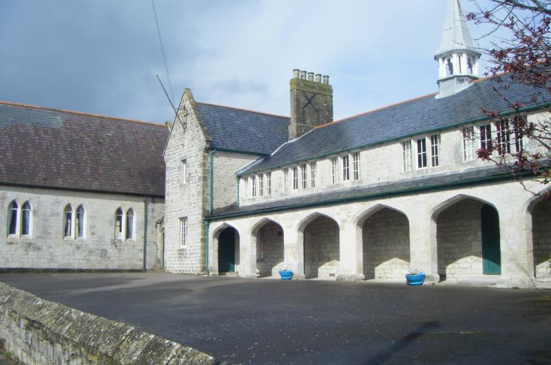 A photograph of a old  stone building with arches
